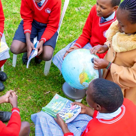 Learners studying around a globe